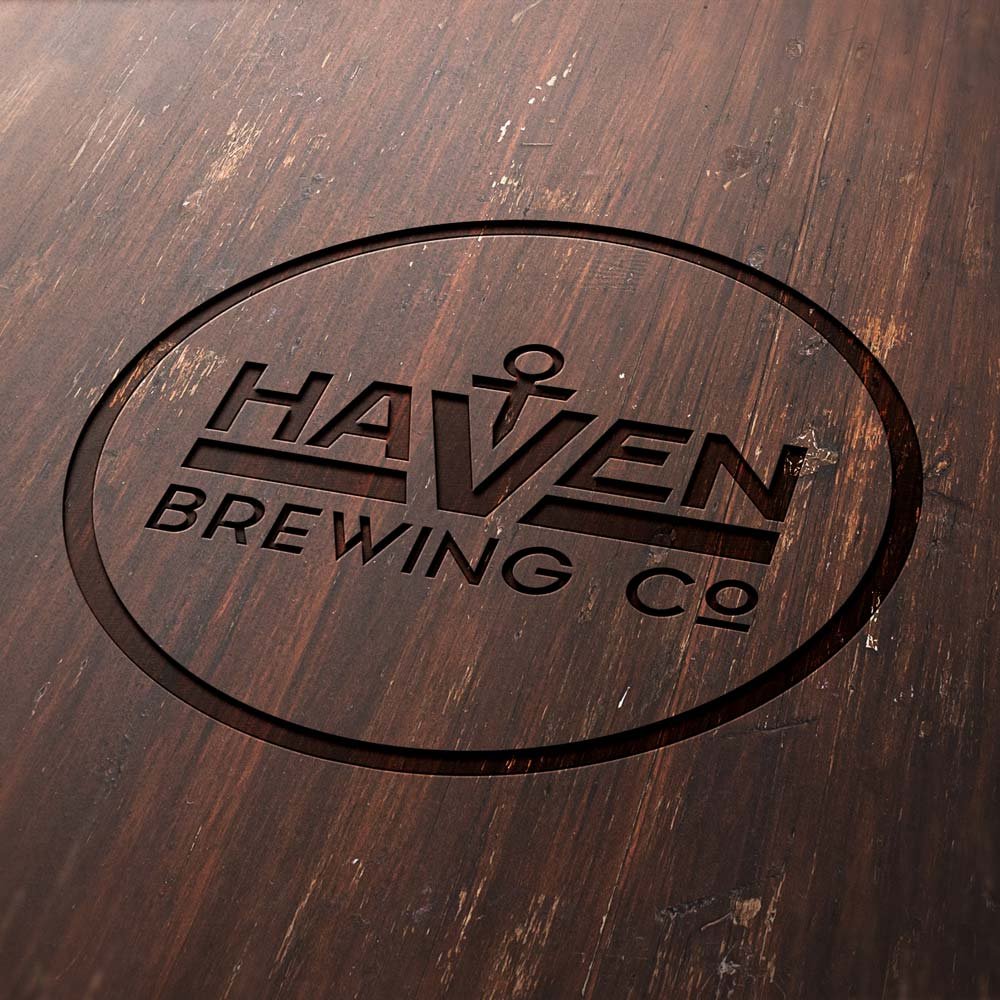 Haven Brewing Company logo engraved in wood.