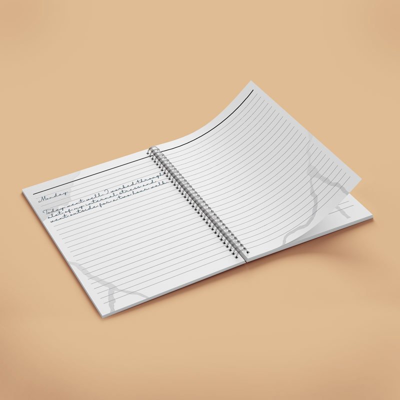 View of spiral notebook inside design on a beige background. 